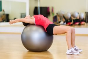 frau macht bandscheibenvorfall übung auf gymnastikball